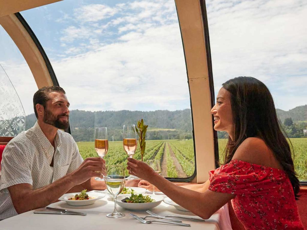 Couple Having Wine And Food On The Train.