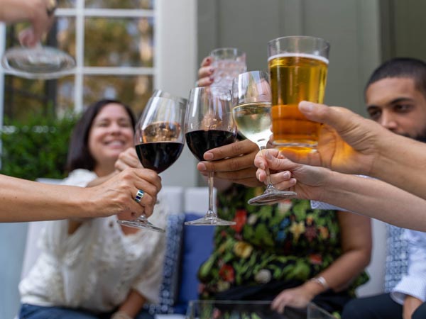Group Toasting With Wine And Beer.